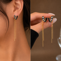 Black heart earring rhinestone accents with dangling chain tassels.