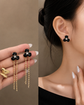 black flower earring with hanging beaded chain dangles.